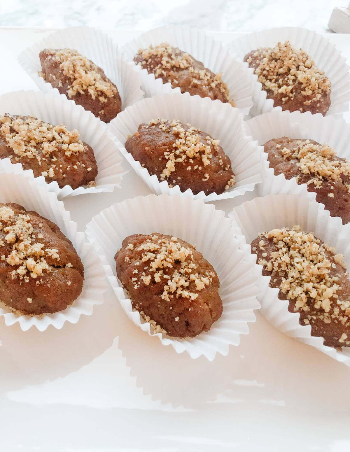 melomakarona cookies in individual wrappers on a serving tray