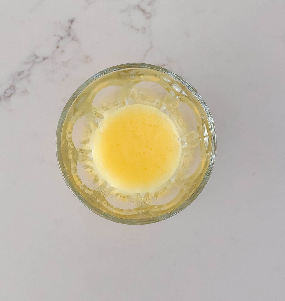 orange juice and baking soda mixed together in a small glass