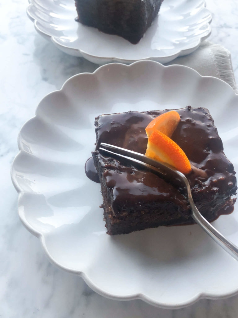 one piece of chocolate orange cake topped with a fresh orange slice