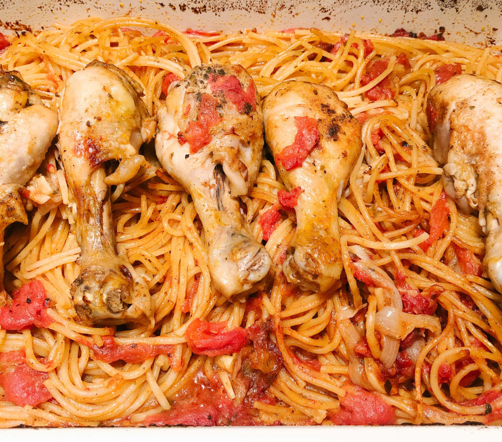 chicken drumsticks baked with spaghetti and tomato sauce