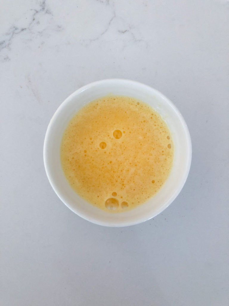 orange juice mixed with baking soda in a small bowl 