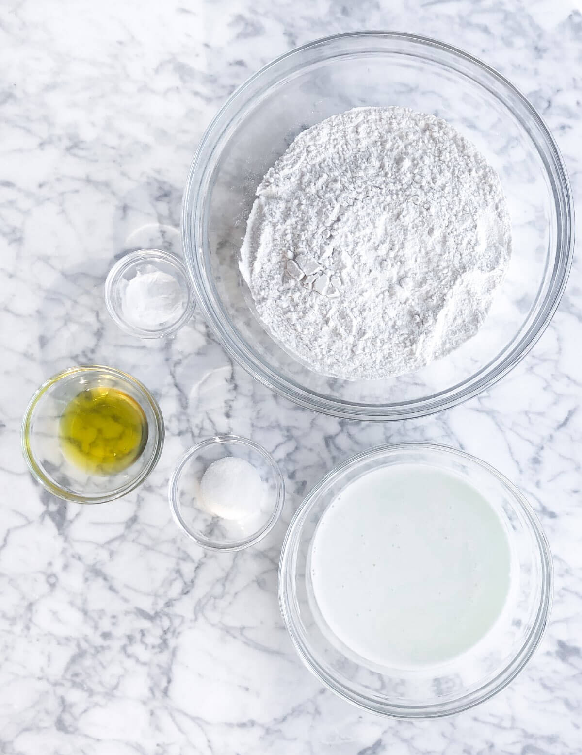 Five glass bowls.  One with flour, baking soda, buttermilk, olive oil and salt.  