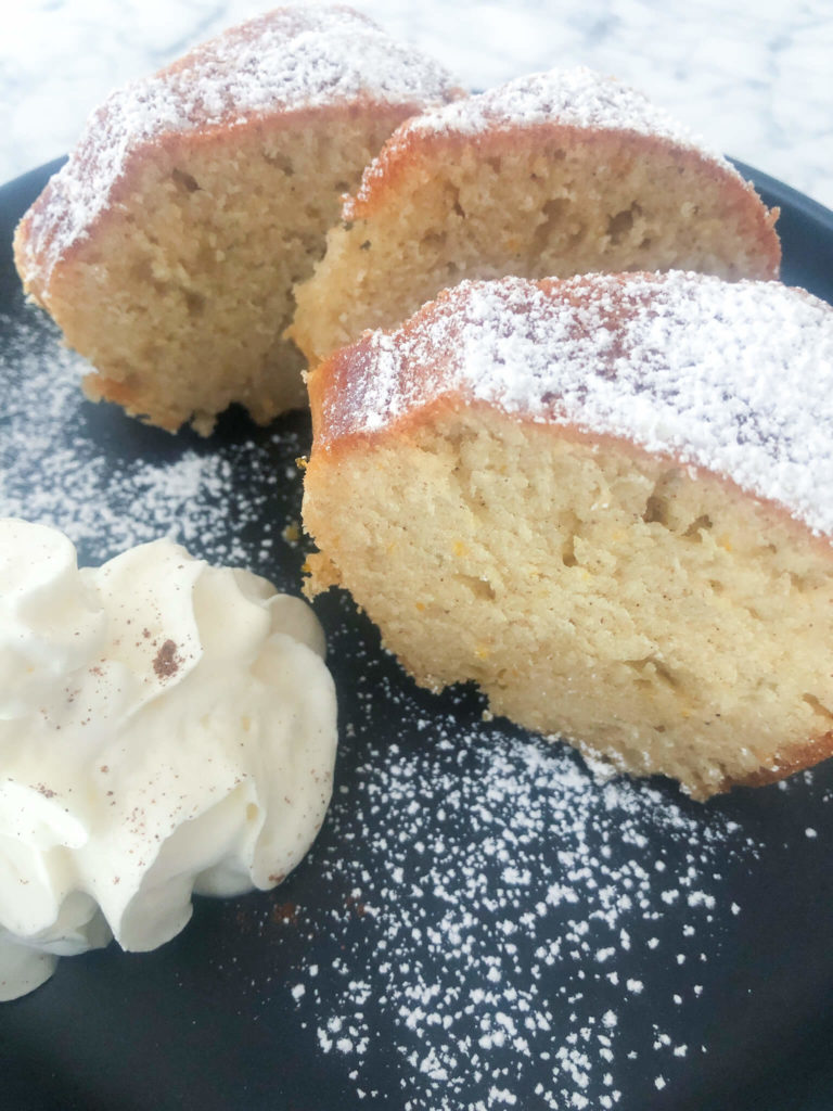 Three slices of greek honey cake with whipped cream