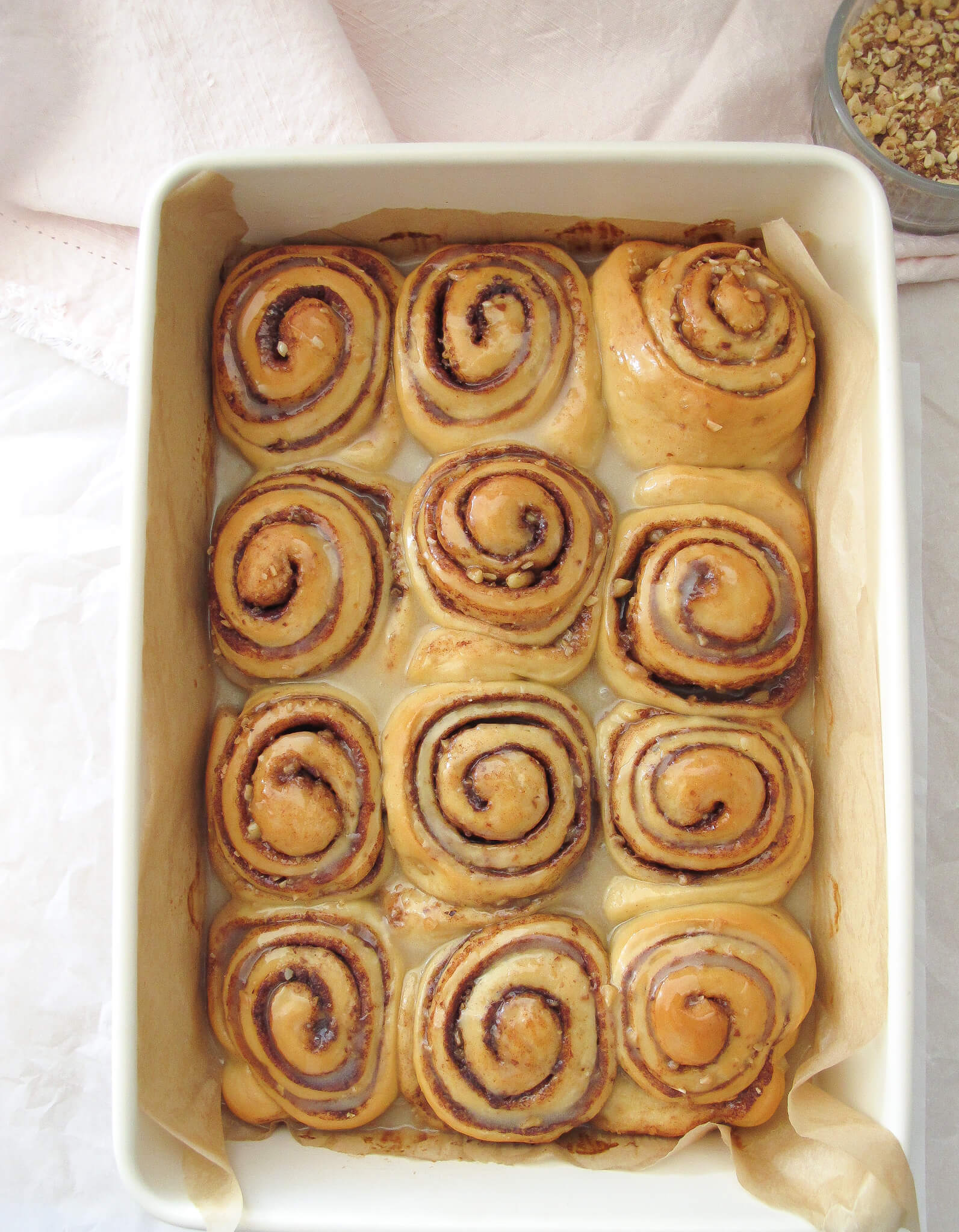 baklava cinnamon rolls baked in a baking dish with icing