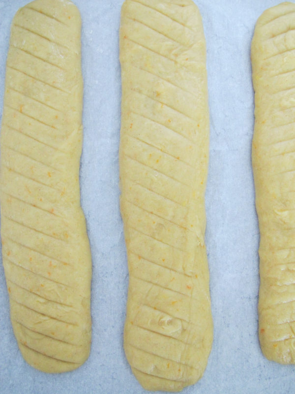 three biscotti logs that are scored into 3/4 inch pieces