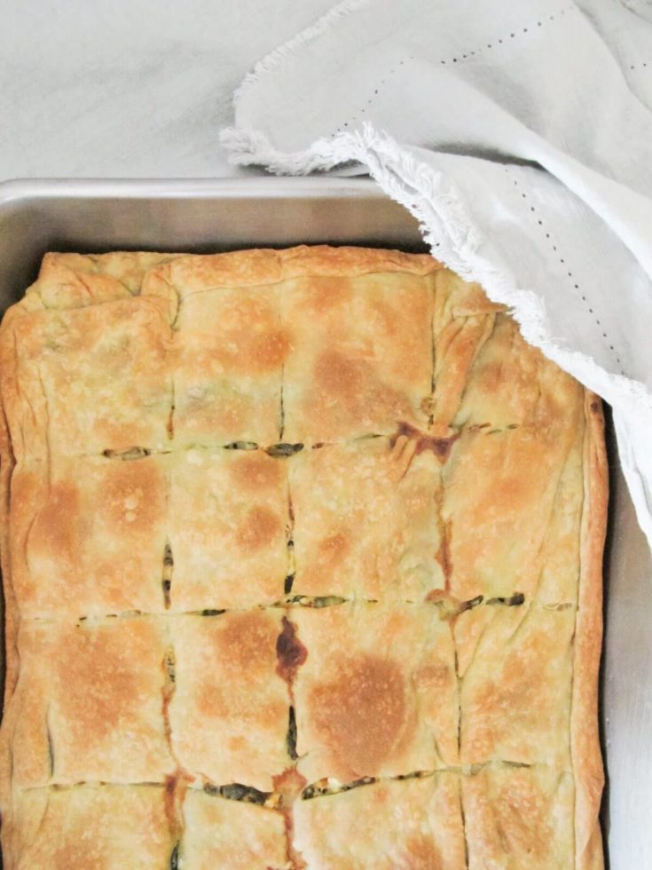 Greek spinach pie baked in a baking dish.