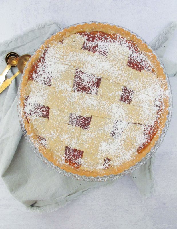 Greek apricot jam tart with a lattice design sprinkled with icing sugar.
