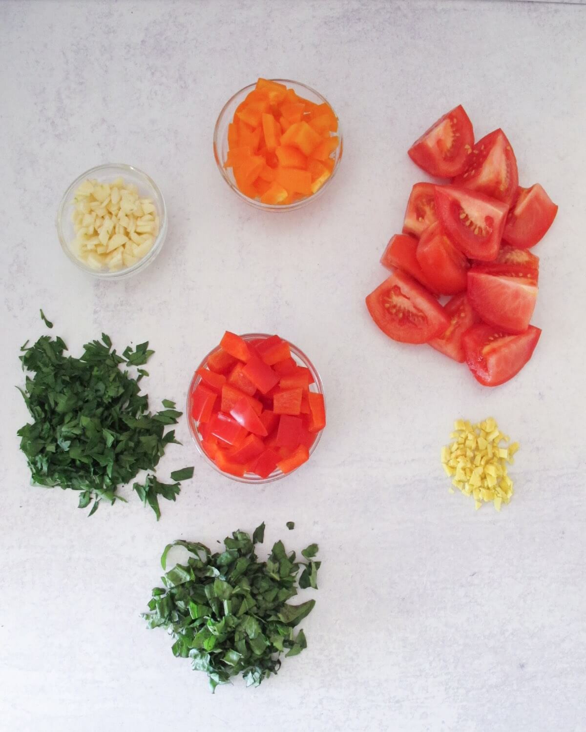 chopped parsley, basil, tomatoes, ginger, red peppers, and orange peppers.