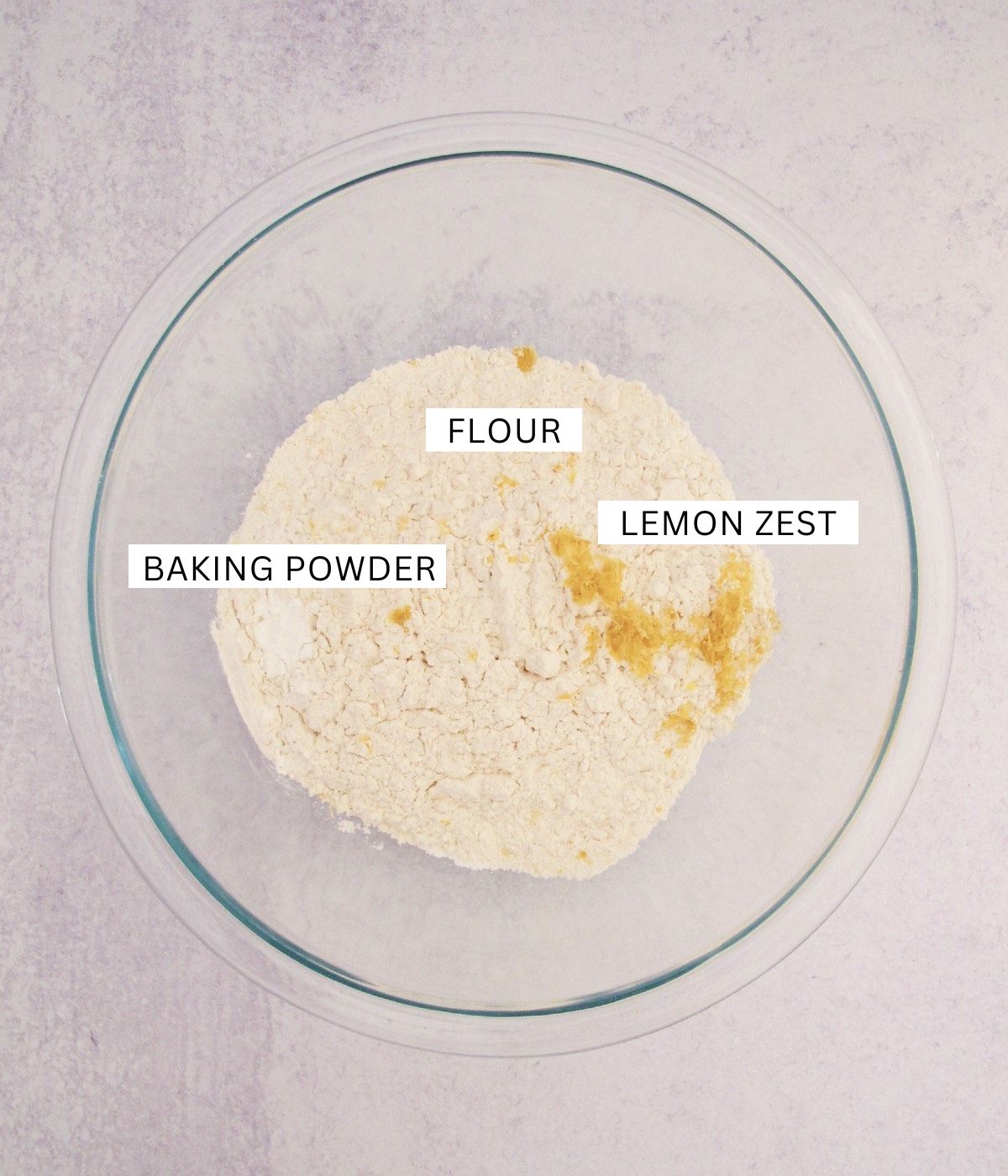 flour, baking powder, and lemon zest in a large glass bowl.