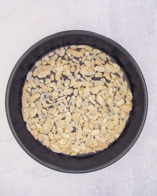 lightly toasted blanched sliced almonds on a round baking sheet.