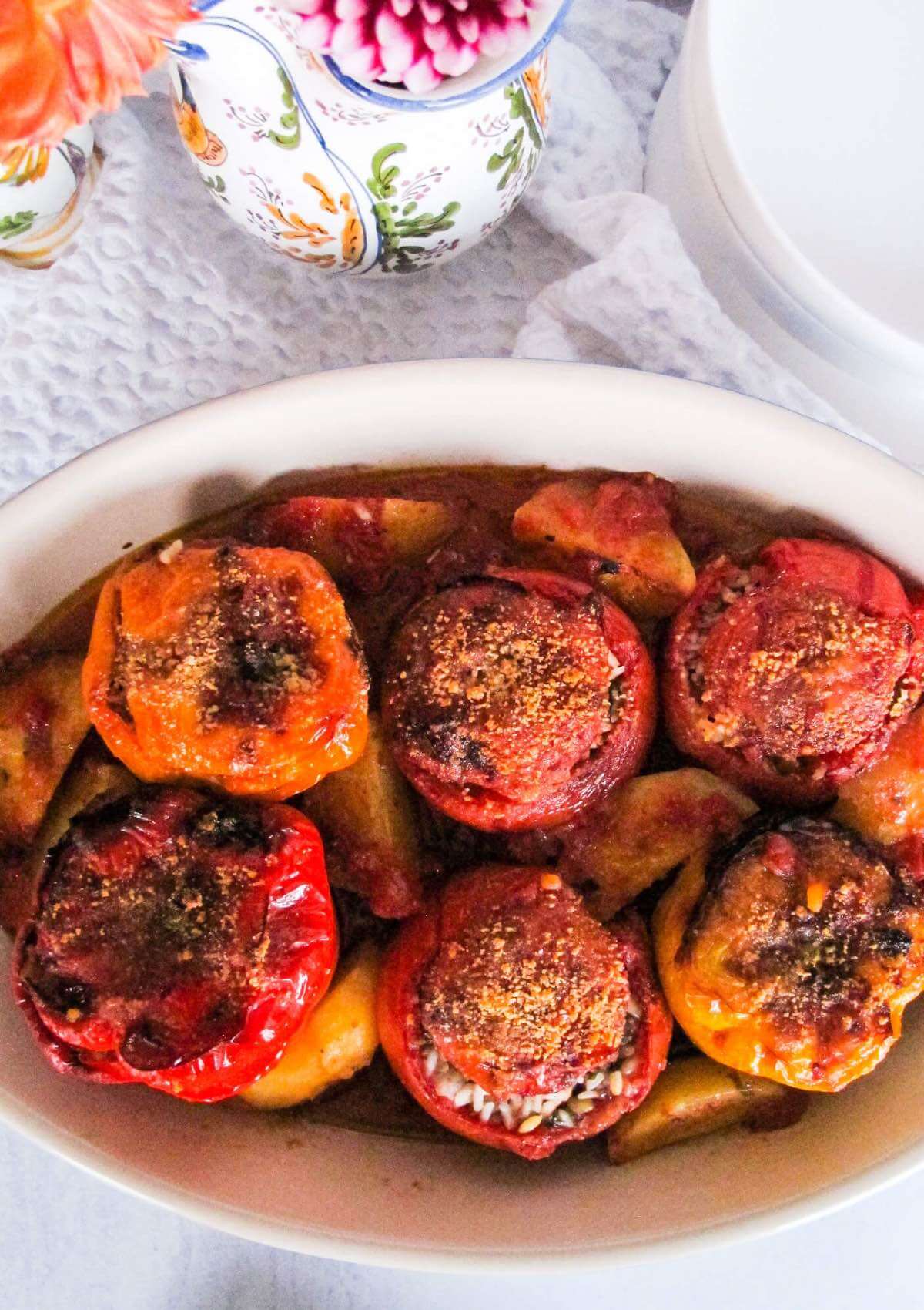 Greek stuffed tomatoes and peppers in a baking dish.