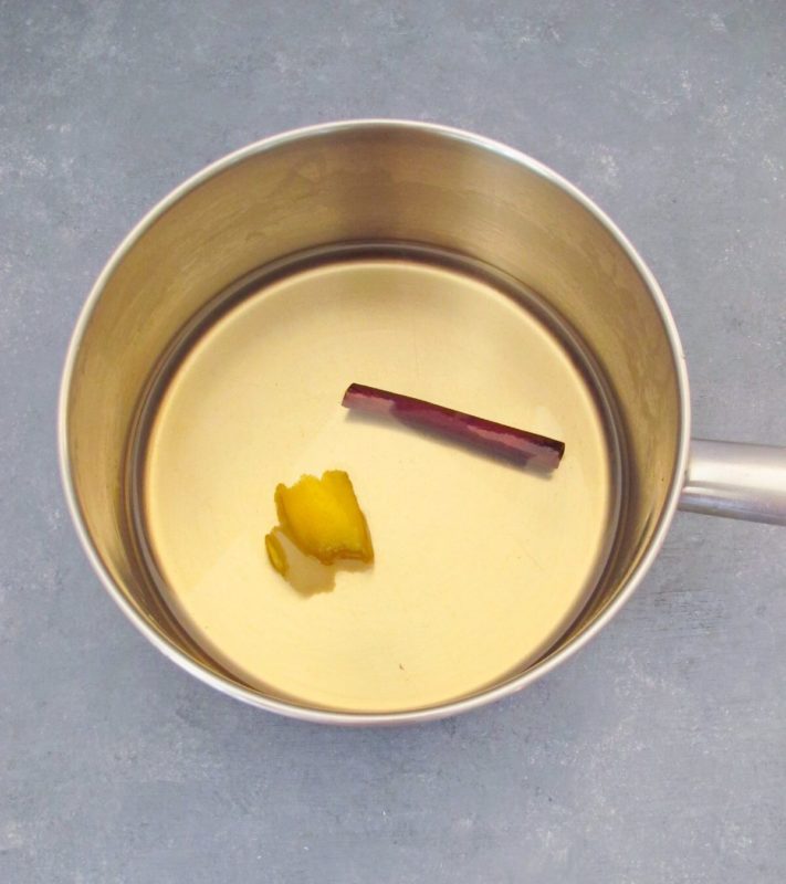 syrup in a small saucepan with a cinnamon stick and lemon peel.