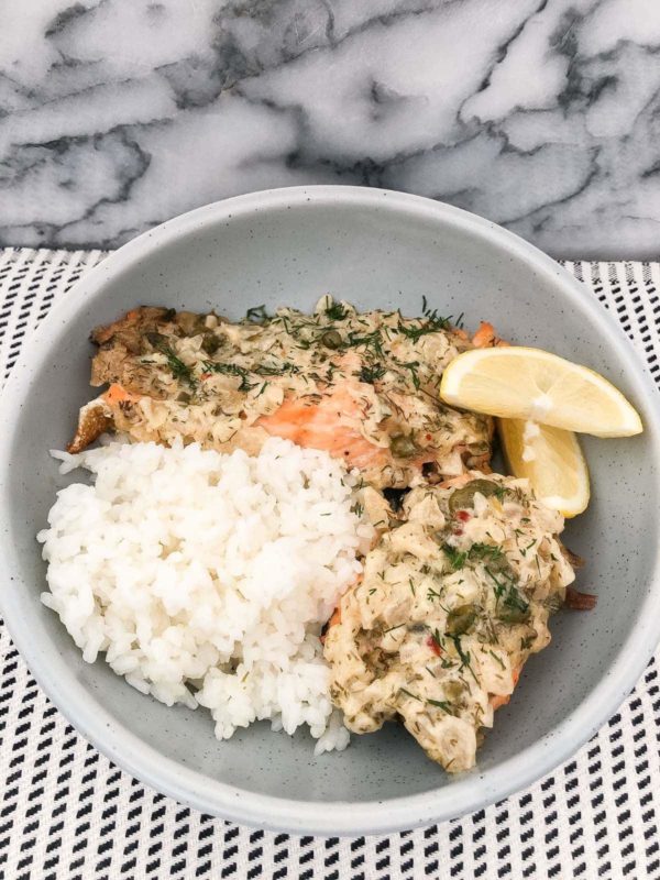 two pieces of salmon with mayo and white rice