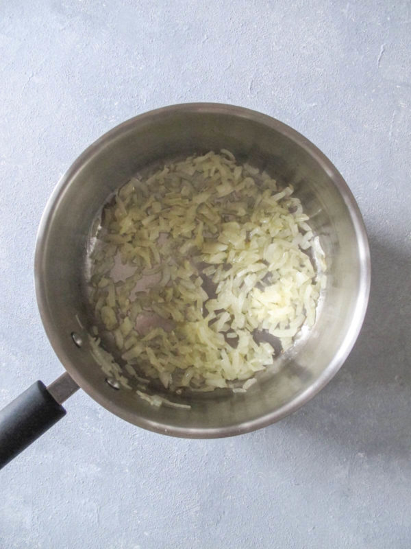 sautéd yellow onions in a saucepan.