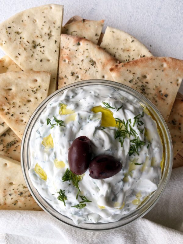 Tzatziki made with sour cream in a bowl with pita bread.