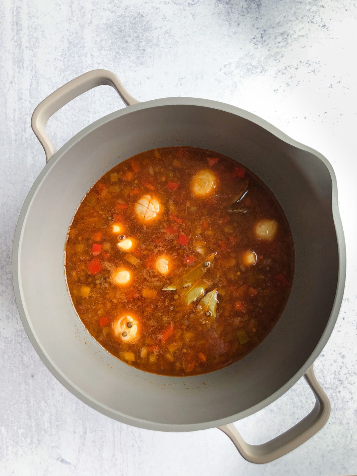 Greek lentil soup (fakes) simmering in a large pot.
