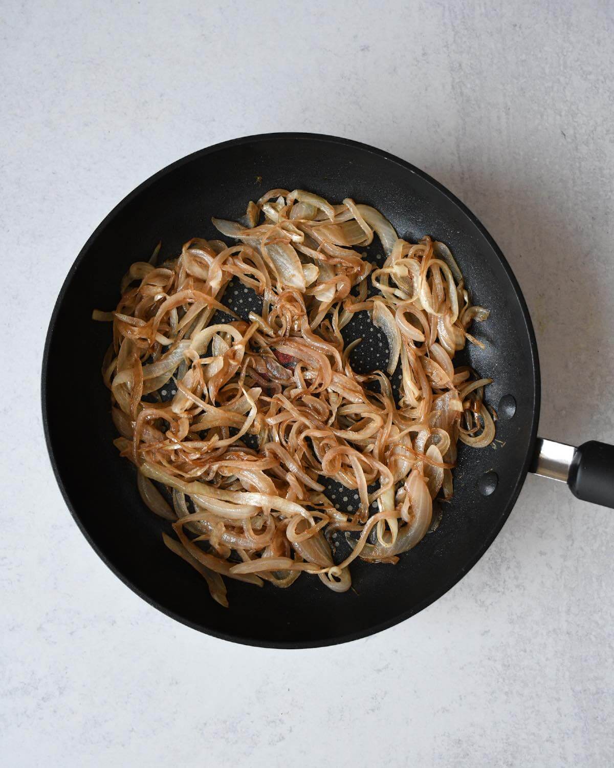 caramelized onions in a frying pan.