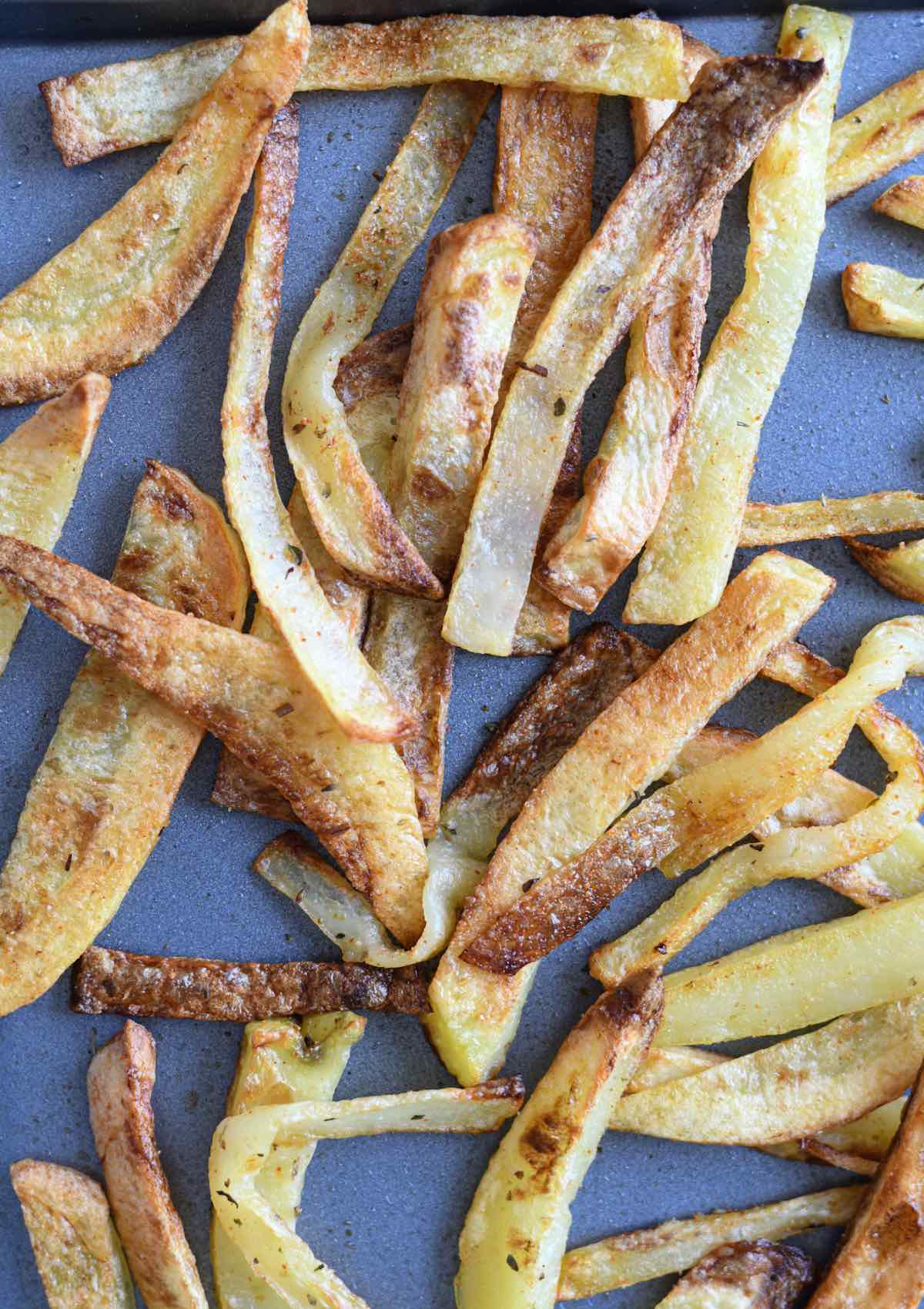 cooked fries on a baking sheet.
