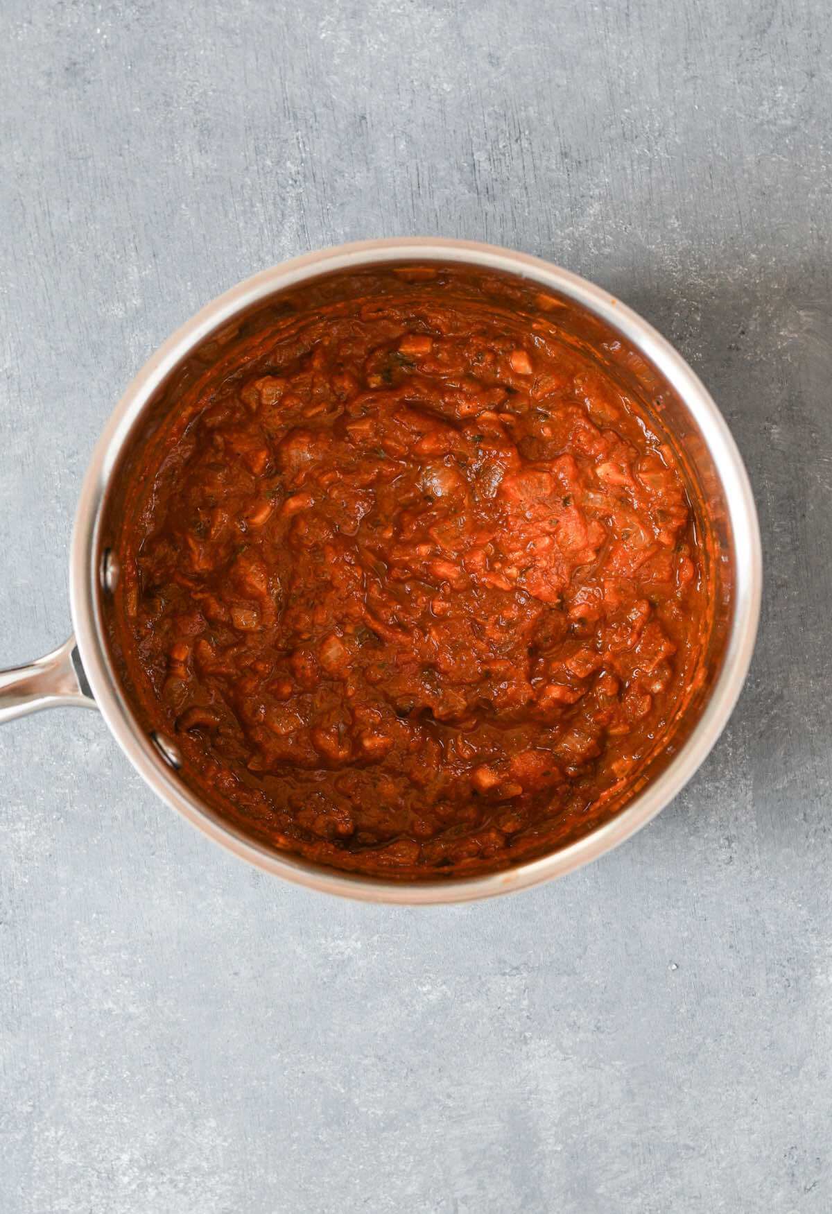 tomato sauce with garlic and onions in a saucepan.