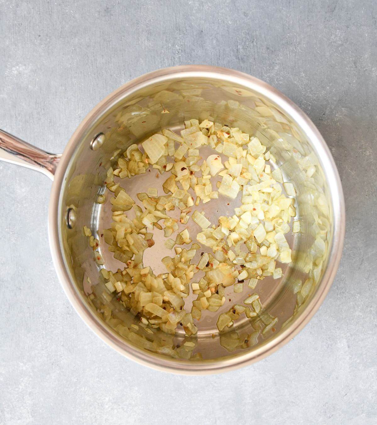 diced onions and garlic sautéing in a saucepan with olive oil. 