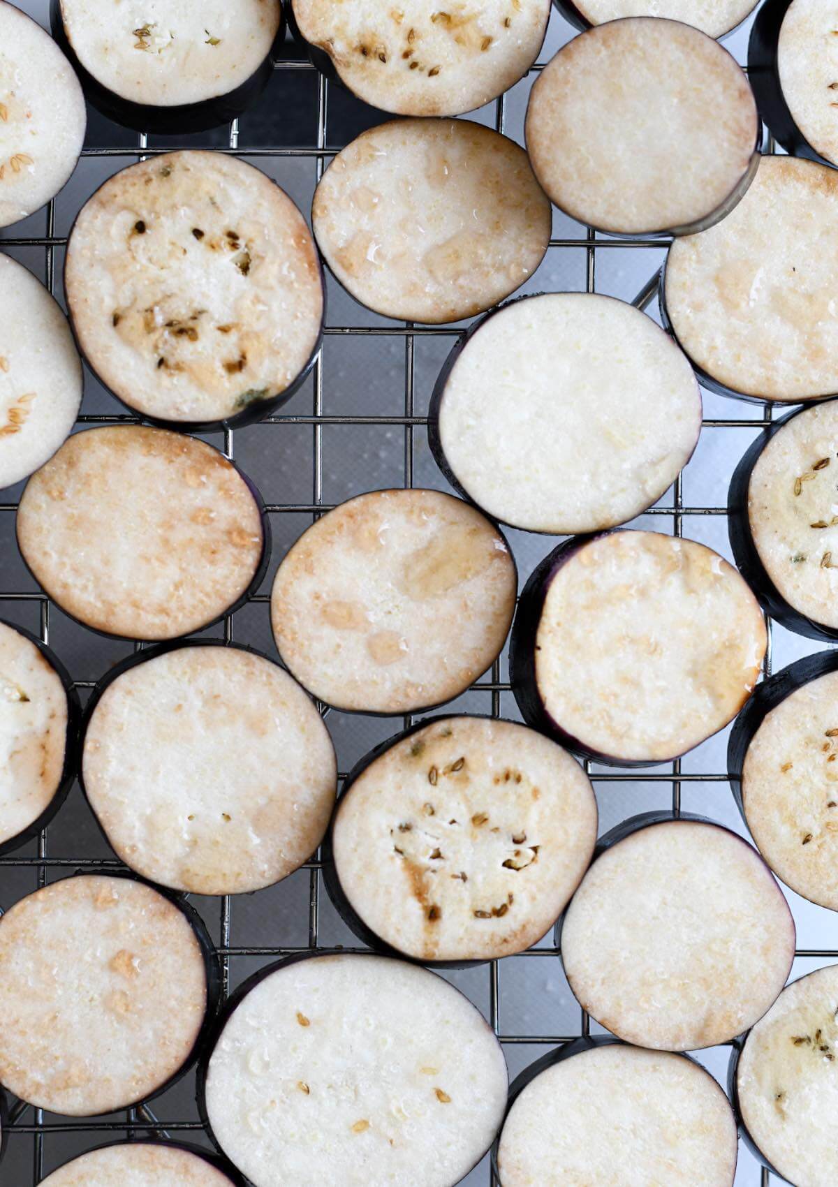 salted sliced japanese eggplant on a wire rack.