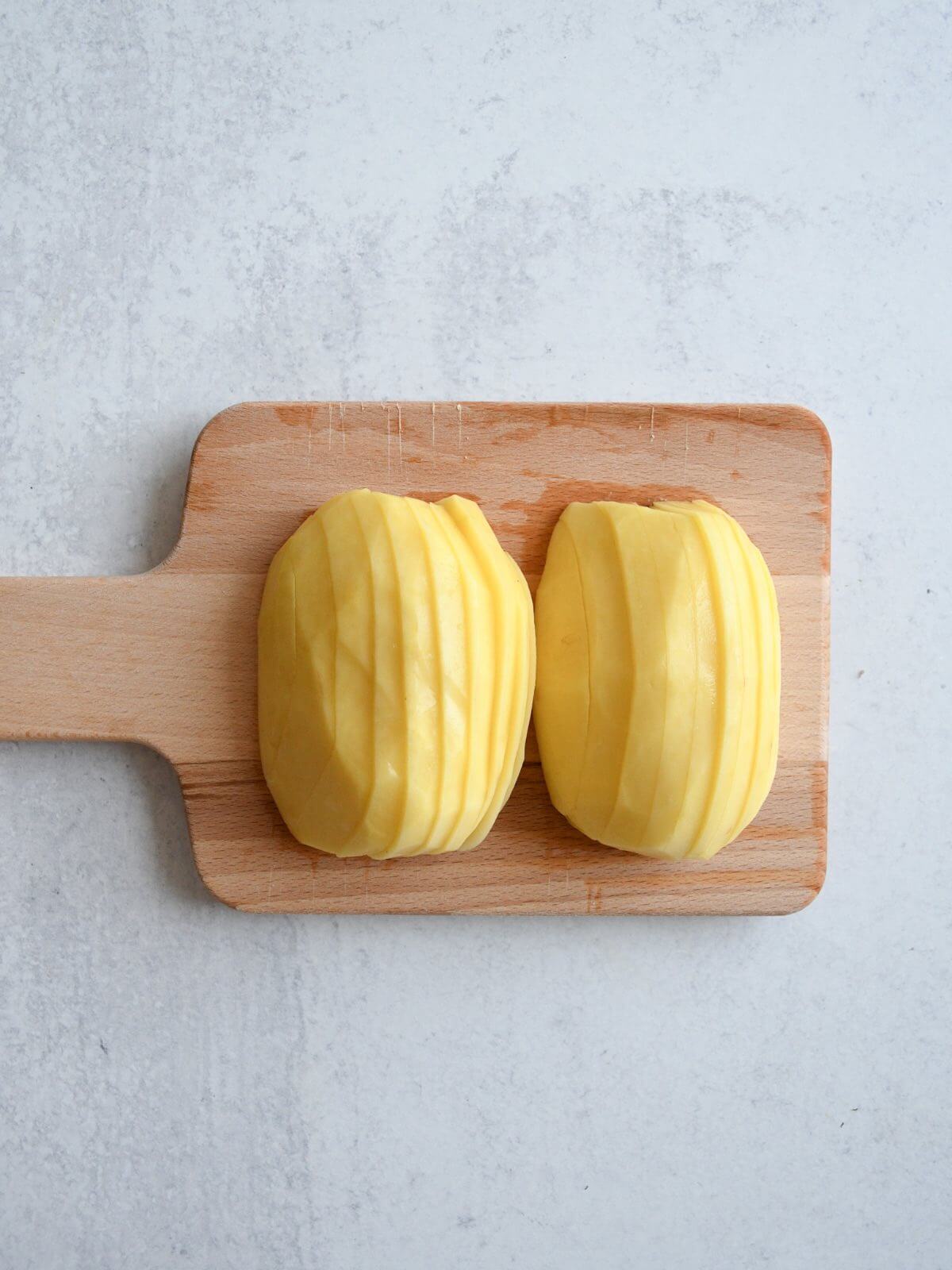 peeled potato cut in half lengthwise and cut into slices.
