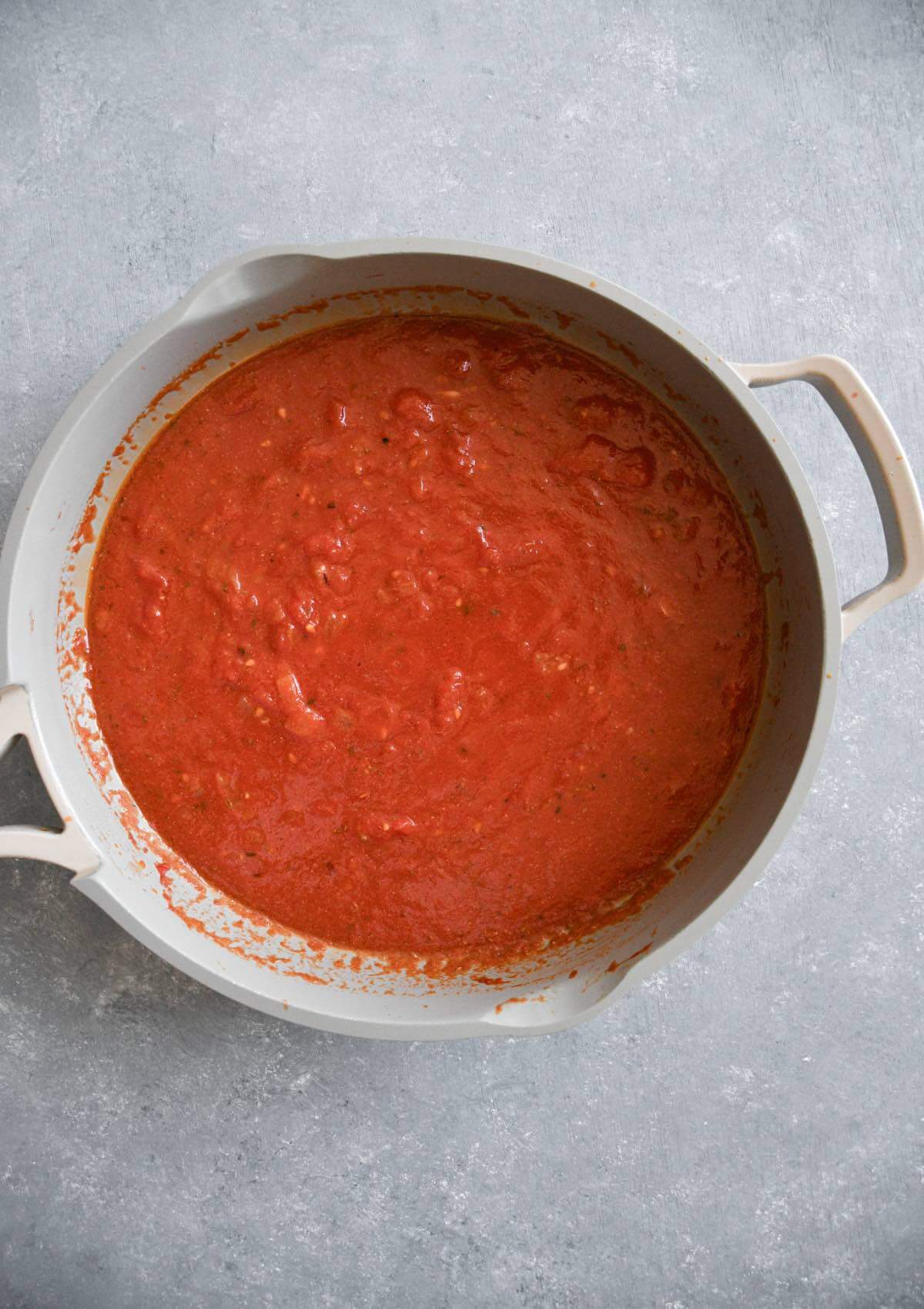 tomato sauce cooking in a frying pan.