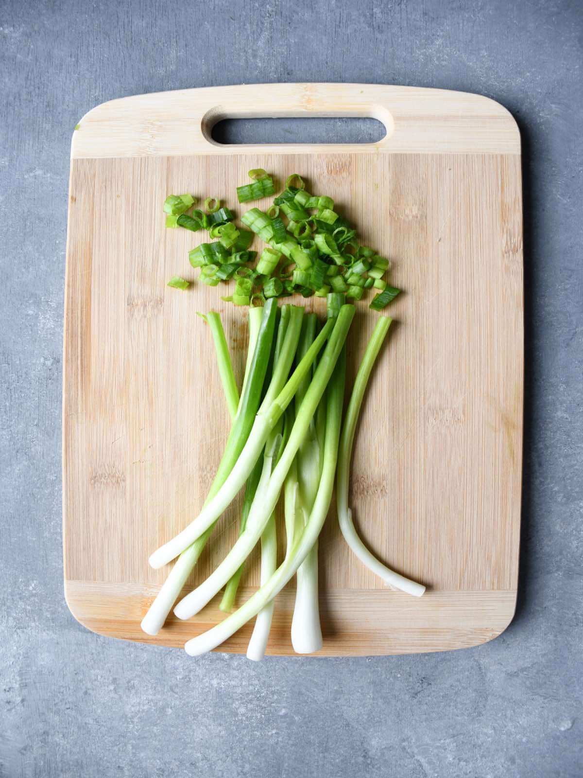 sliced green onions on a cutting board.