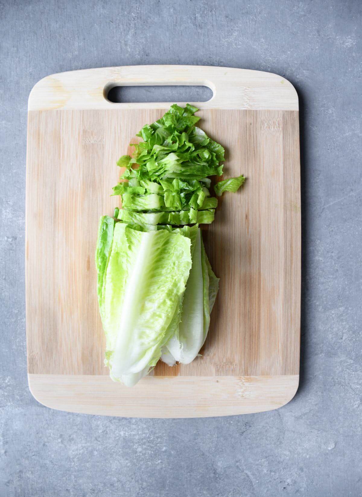 sliced romaine lettuce on a cutting board.