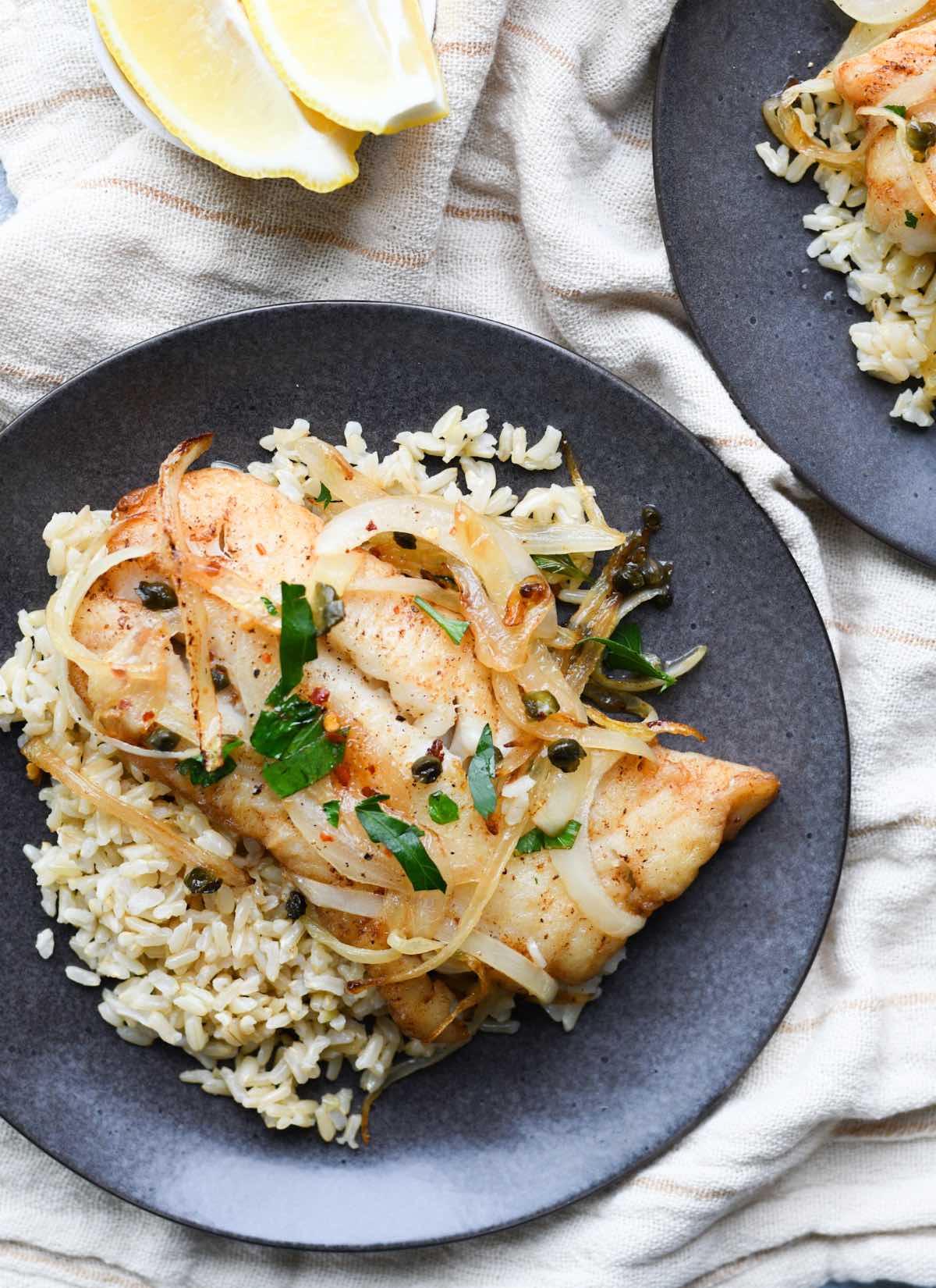 pan-fried cod fillets in a butter caper sauce served over white rice.