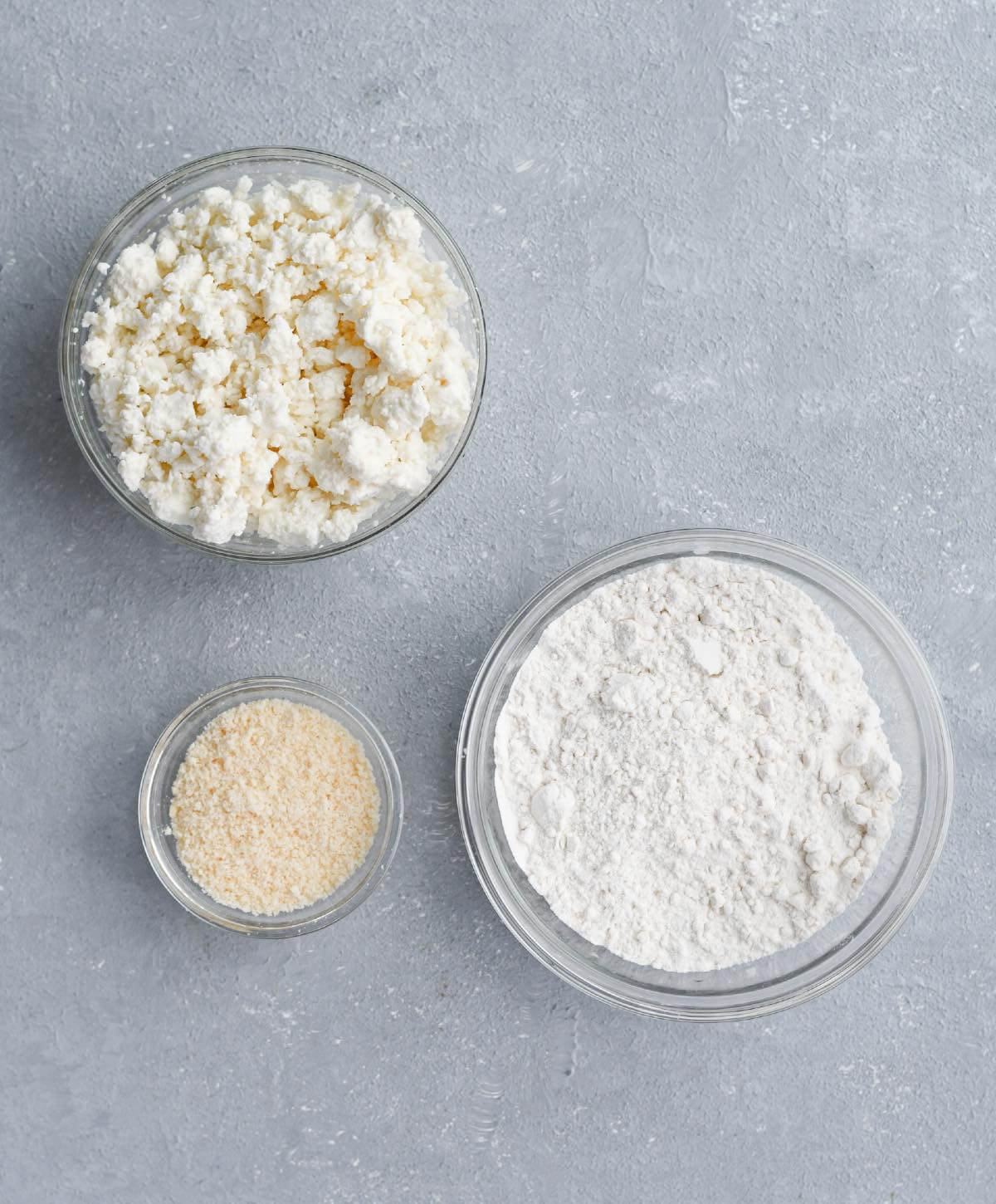 crumbled feta, flour, and breadcrumbs in individual glass bowls.